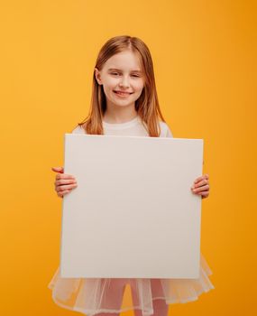 Girl with canvas isolated on yellow background