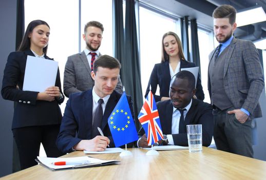 Two business partners signing a document. The European Union and Great britian. Brexit