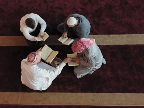 top view of muslim people in mosque reading quran together