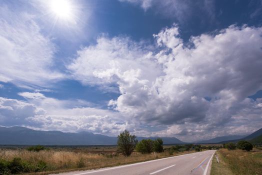 asphalt road in beautiful countryside on sunny summer day