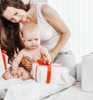happy mothers her infant baby consider holiday shopping, folded
