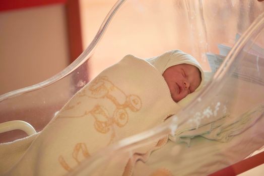 newborn baby sleeping in bed at hospital