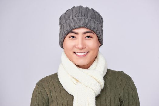 Handsome winter asian man in knitted woolen clothing hat