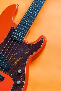 orange electric bass guitar