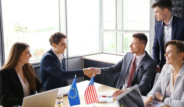 European Union and The United States leaders shaking hands on a deal agreement.
