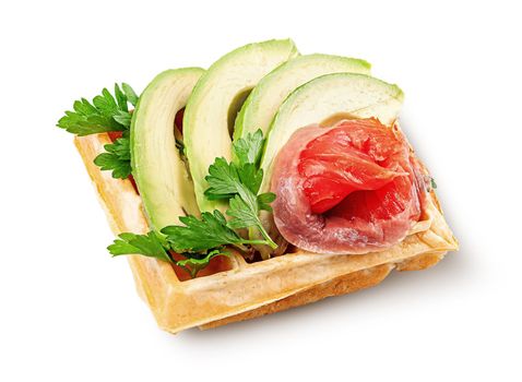 French waffle with avocado and salmon isolated on white