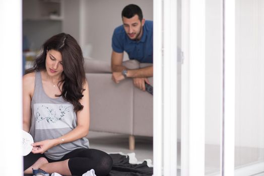 pregnant couple checking a list of things for their unborn baby