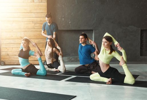 Group with yoga instructor in fitness club