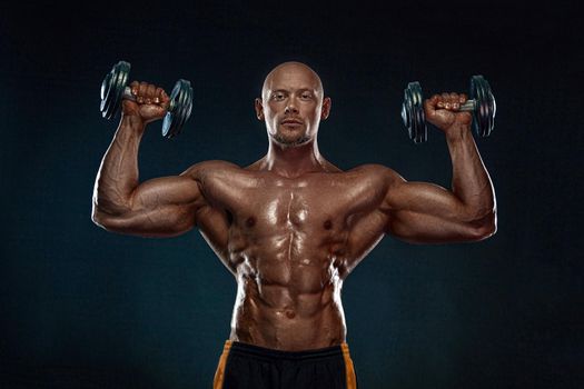 Bodybuilder posing. Beautiful sporty guy male power. Fitness muscled man