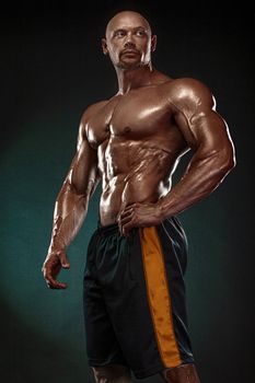 Bodybuilding competitions on the scene. Handsome and fit man sportsmen bodybuilder physique and athlete. Men's fitness and sport motivation. Individual sports recreation.