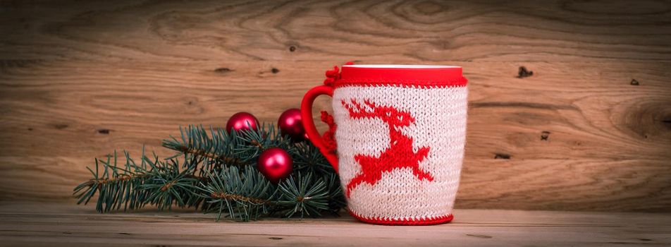 Christmas Cup and fir branch on wooden background