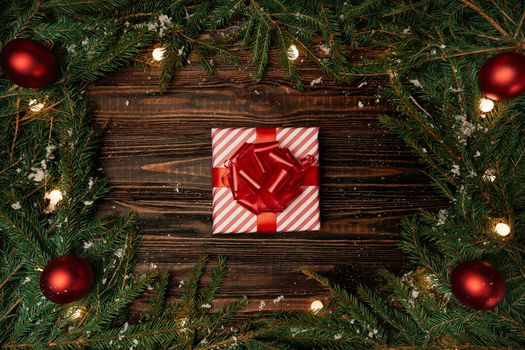 gift box and a Christmas garland on a wooden background .