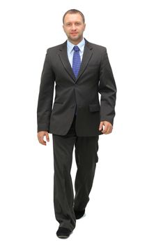 young businessman is walking. He is smiling and looking to the camera. isolated over white background