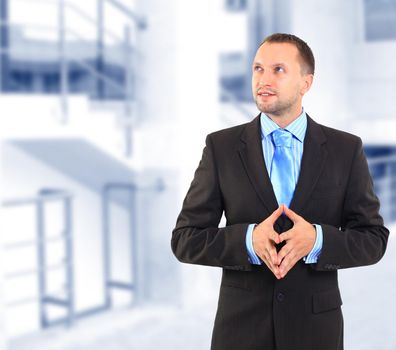 Businessman standing on white background, looking off into distance