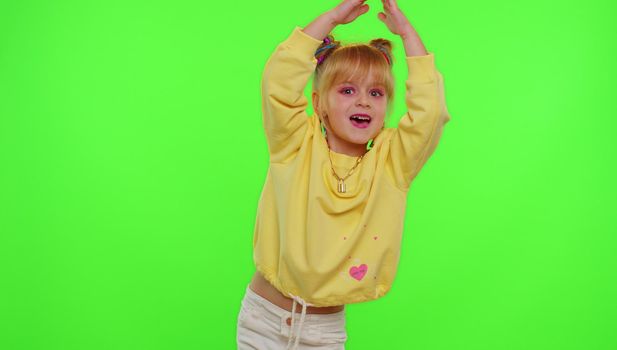 Dancing young little kid girl blogger record dance moves at camera for social media content on phone
