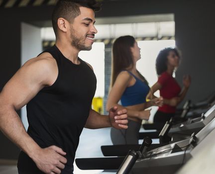 Sport concept. Happy man exercising on treadmill