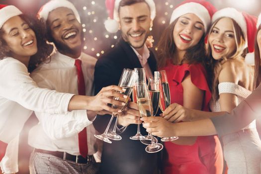 Diverse friends clinking with champagne glasses on New Year's Eve