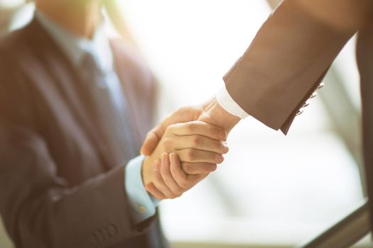 businessman shaking hands to seal deal with his partner