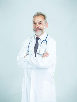 experienced therapist with a stethoscope on light background.