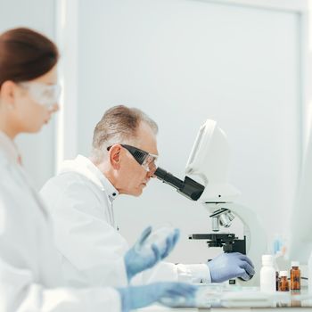 pharmacists from all over using microscope in the laboratory.