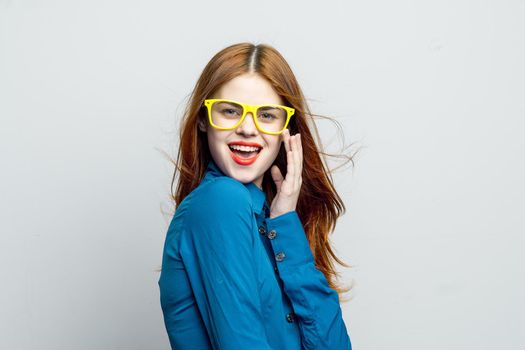 woman in blue shirt yellow glasses posing fashion