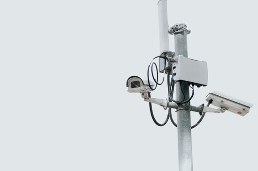 CCTV camera electric pole on isolated white sky with copy space. Safe and secure technology outside property and homeowner concept. Security card device and gadget theme. Outdoor electronic