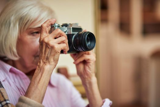 Beautiful elderly lady is using rare camera