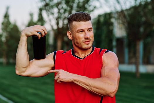 sporty man in red jersey muscle workout park