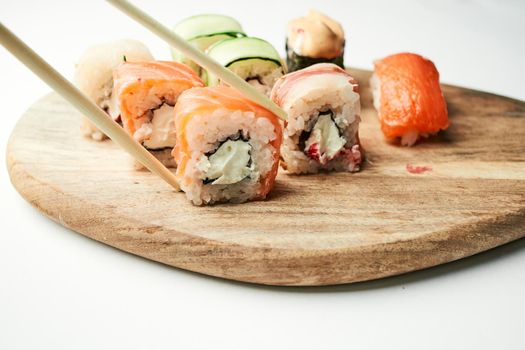 sushi rolls wood board japanese cuisine restaurant. High quality photo
