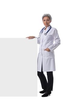 Mature asian female doctor holding blank banner isolated on white background