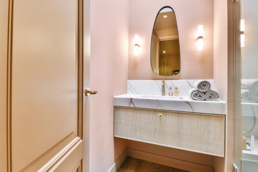 Luxurious washroom with peach walls and marble top