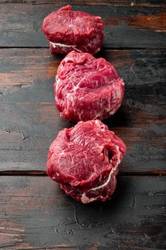Prime Raw Fillet Mignon tenderloin steaks, on old dark wooden table background