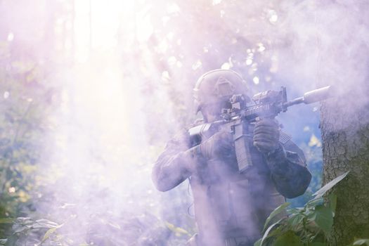 soldier in action aiming  on laser sight optics