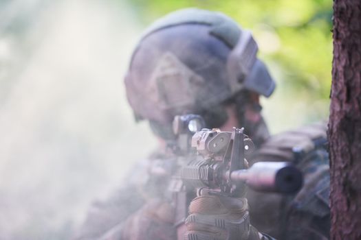 soldier in action aiming  on weapon  laser sight optics