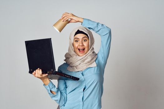 muslim woman in hijab with laptop coffee cup work