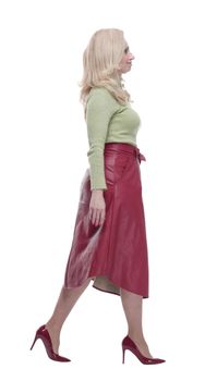 young woman in a fashionable red skirt striding forward