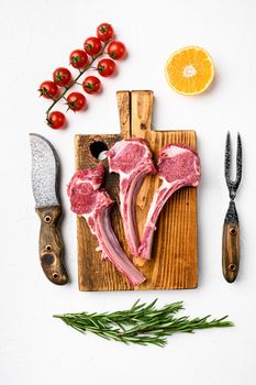 Uncooked mutton rack of lamb, on white stone table background, top view flat lay