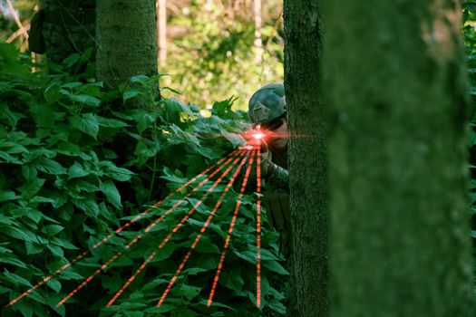 soldier in action aiming  on laser sight optics