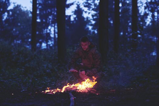 soldiers resting by fire in forest