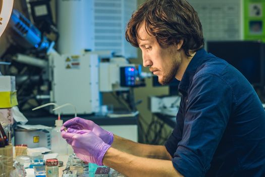 Scientist in a laboratory prepare a sample for an elecron microscopic investigation