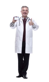smiling doctor showing his visiting card . isolated on a white