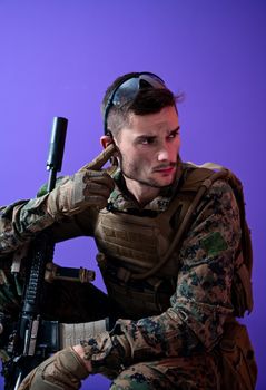 soldier preparing tactical and communication gear for action battle purple background