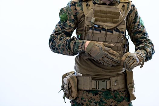 closeup of soldier hands putting protective battle gloves