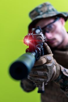 soldier in action aiming laseer sight optics green background