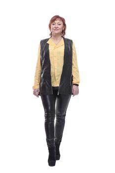 mature woman in leather trousers striding forward.