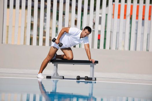 young man exercise at poolside