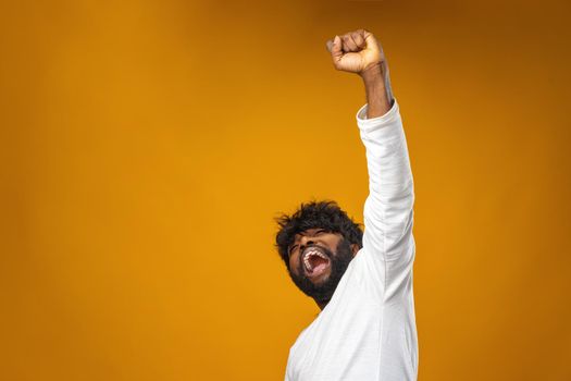 Portrait of overjoyed black man celebrating success