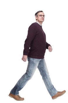 casual man in jeans and jumper striding forward