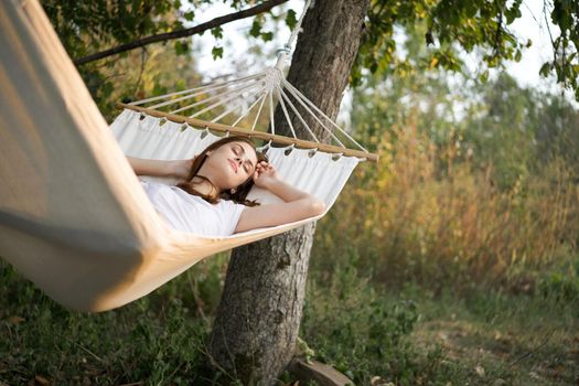 woman sleeping in hammock outdoors leisure lifestyle