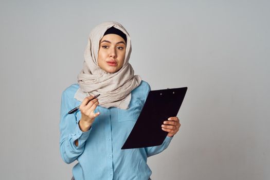 Muslim woman in hijab documents office work